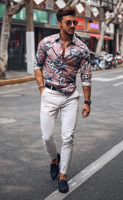 Stylish men's look of a painted pink shirt and white trousers